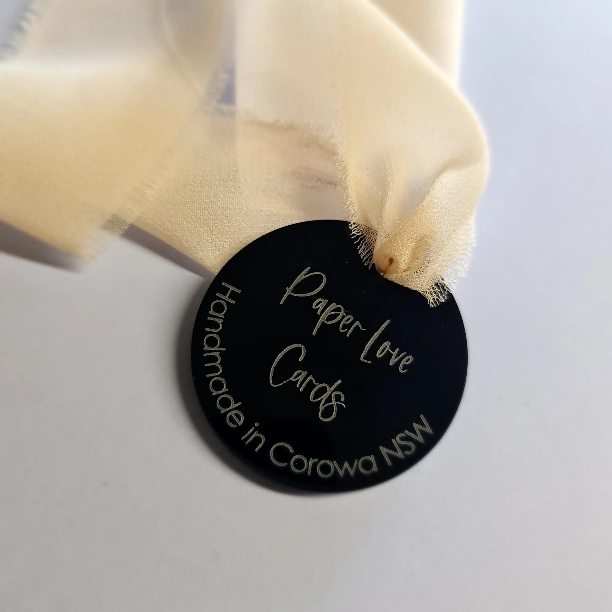 Black acrylic swing tag with laser etching