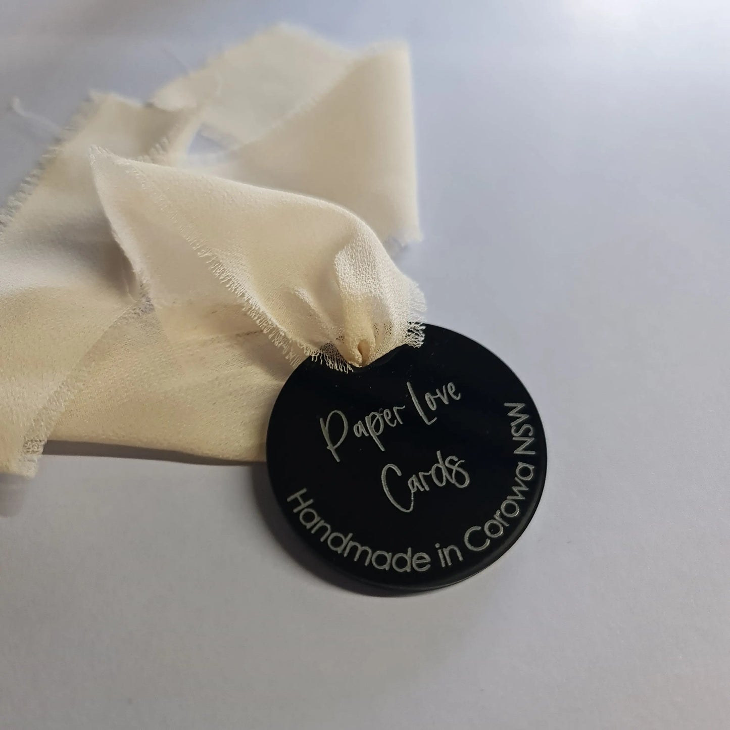 Black acrylic swing tag with laser etching