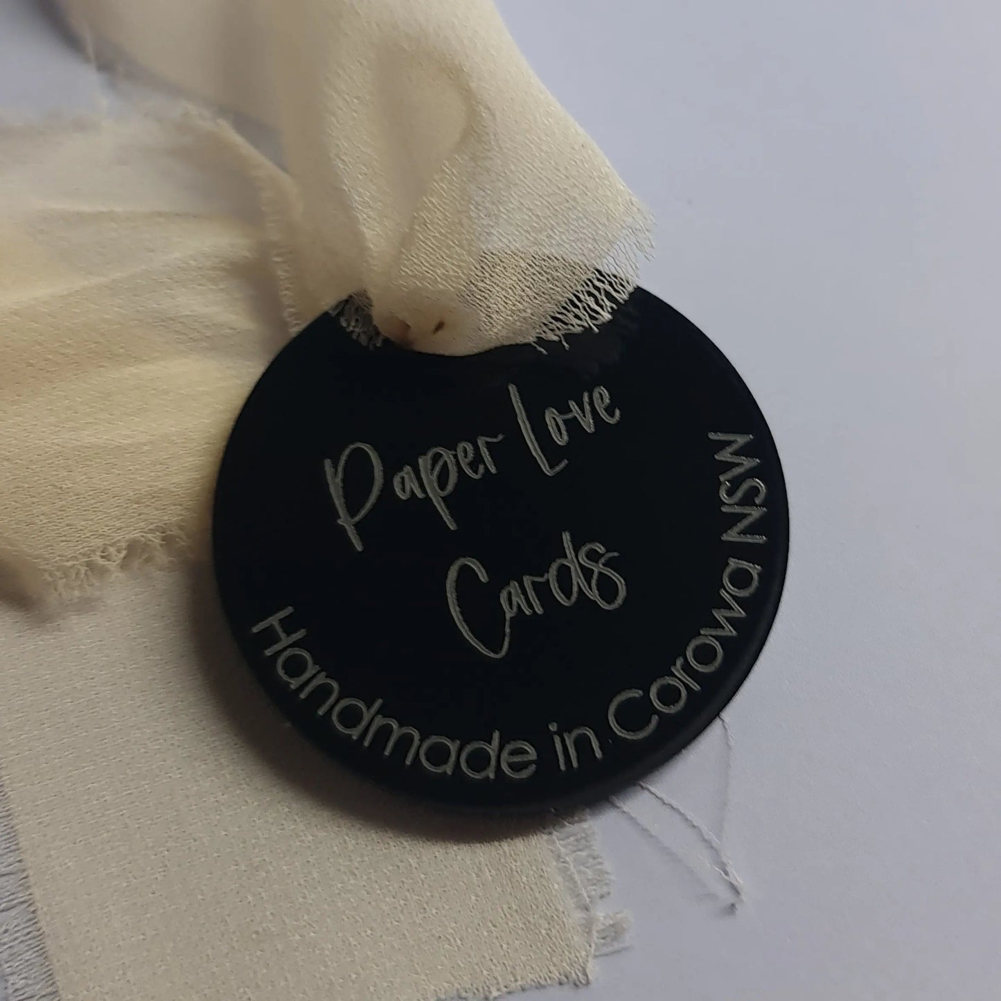 Black acrylic swing tag with laser etching