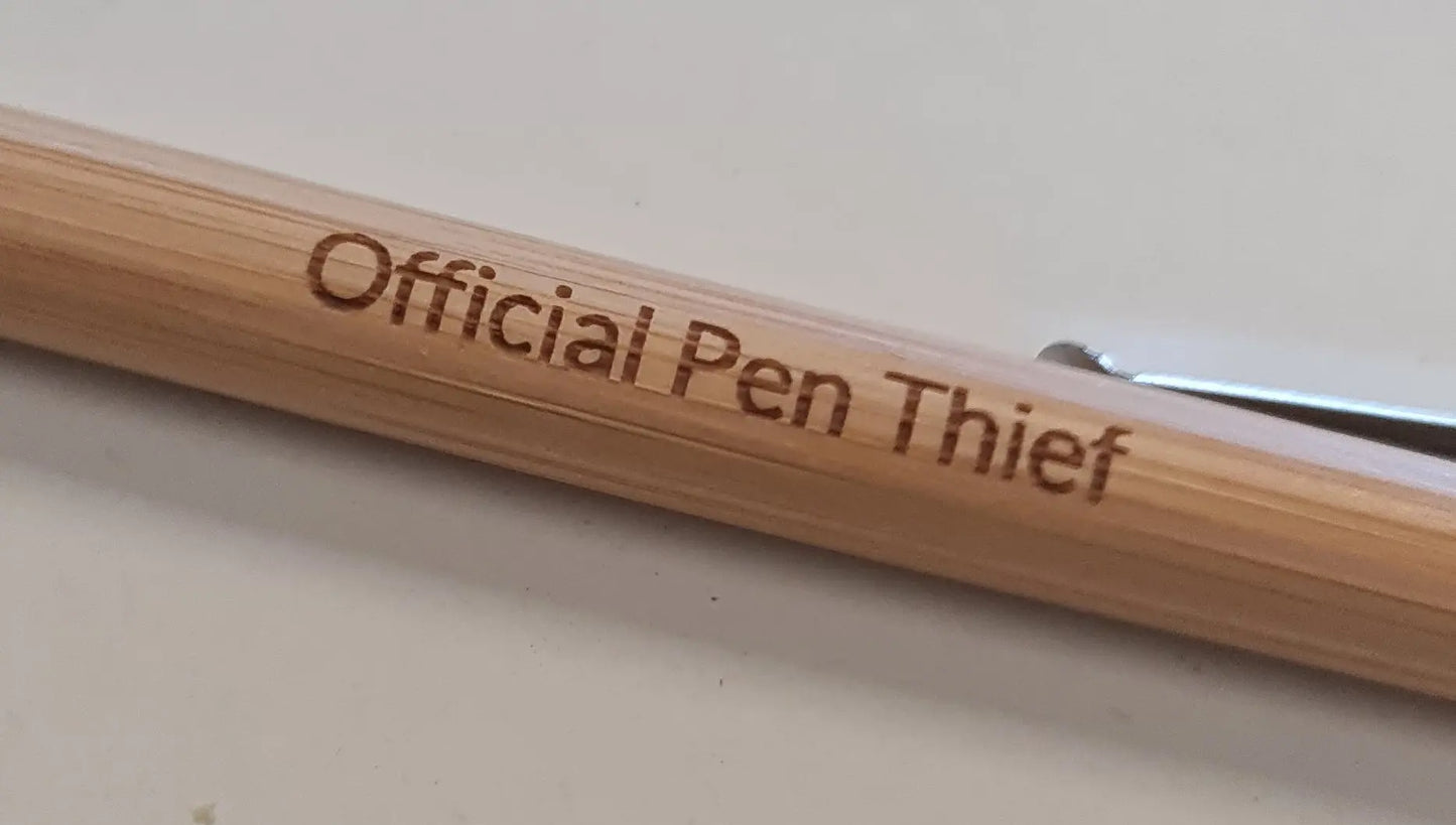 Wooden pen with 'Official Pen Thief' branding on a light background