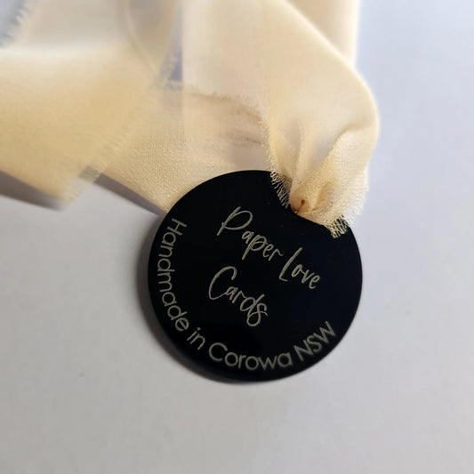 Black acrylic swing tag with laser etching
